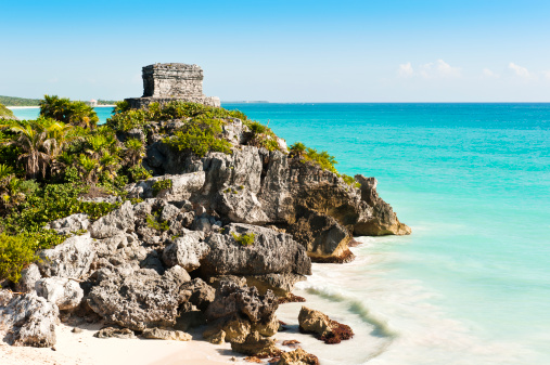 Ruins of the ancient Mayan city of Tulum in Mexico taken on warm summers day with clear blue skies and turquoise caribbean seas. Tulum was one of the last cities inhabited by the Mayas.