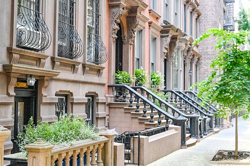 Residential street in New York City with old townhouses. Summer time. Brooklyn.