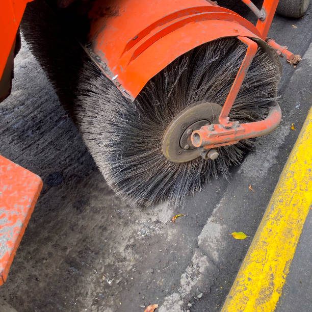 close up on circular brush of street sweeper vehicle