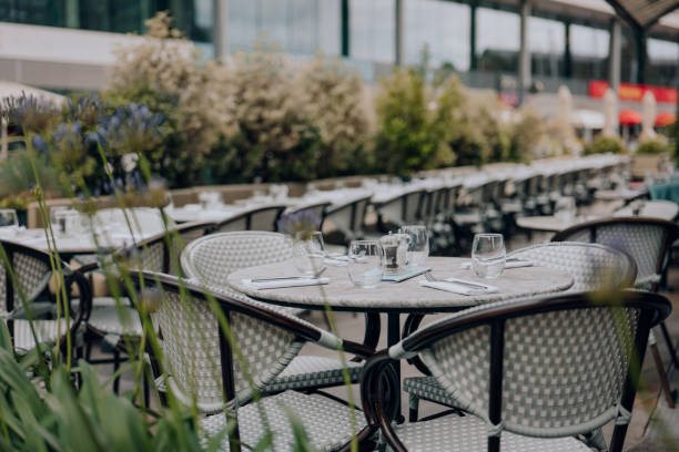 istock Set outdoor restaurant tables in London, UK, selective focus. 1602125151