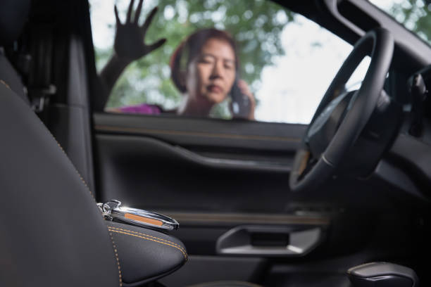 Senior asian woman  forgot her key inside locked car. stock photo