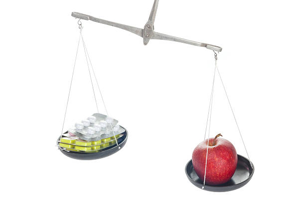 istock Laboratory balance with pill and apple 160224816