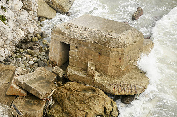 An old World War Two military pillbox fallen into the sea and eroded by the waves. This pillbox is located in Gibraltar and would have looked out to sea across the Straits Of Gibraltar.