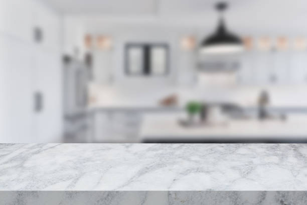 istock Empty white marble stone table with a defocused background of a kitchen 1602258539