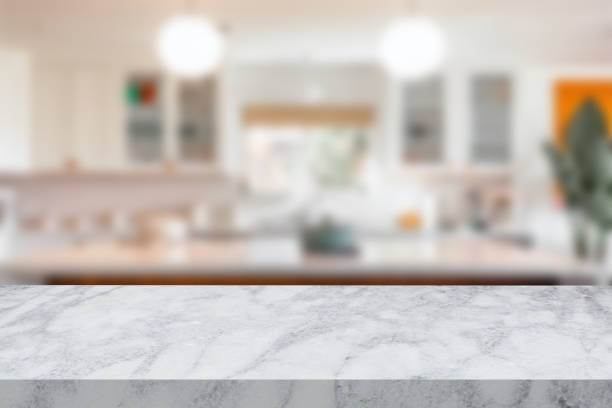 istock Empty white marble stone table with a defocused background of a kitchen 1602258540