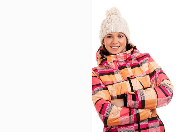 istock Woman in worm cloth standing by blank board 160226376