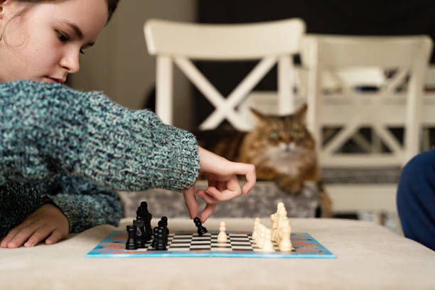 istock Young girl playing chess 1602275248