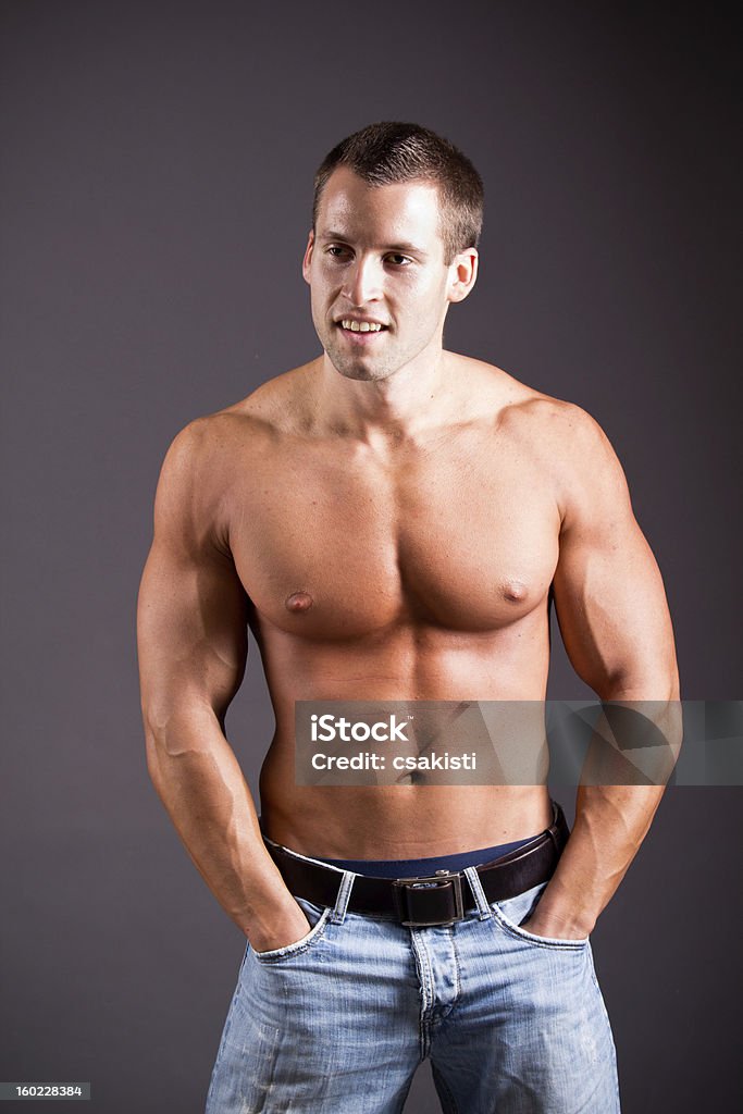 muscular man young muscular man flexing his muscles Abdomen Stock Photo