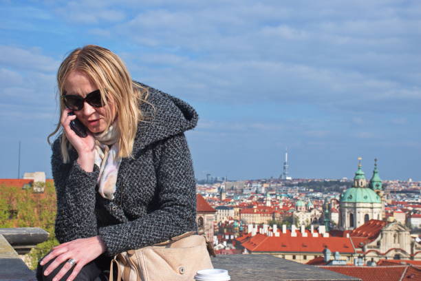 istock Mature woman sitting on the wall 1602290005