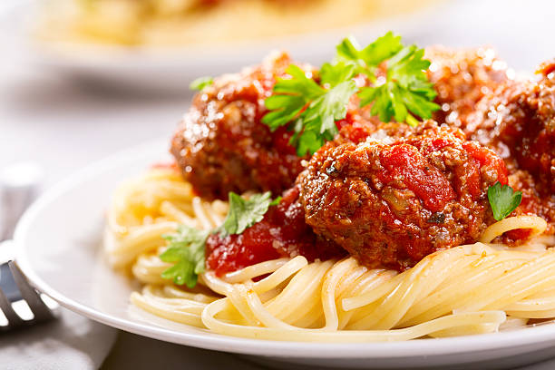 pasta mit fleischklößchen und petersilie - spaghetti stock-fotos und bilder