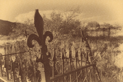 A sepia colored image of a grave in the Hogback Cemetery, Jerome, Arizona.