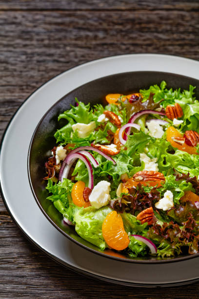 istock Mandarin Orange Salad in black bowl, top view 1602322454