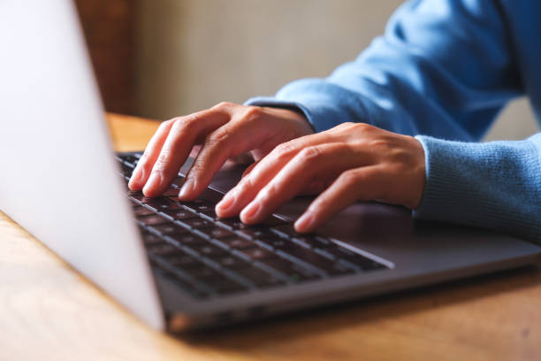 istock Closeup image of a woman working and typing on laptop computer 1602334181