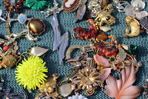 Selection of vintage pins and brooches at flea market.