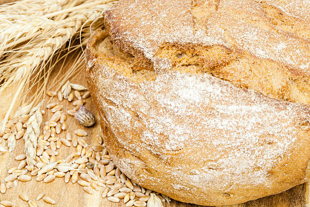 istock fresh bread with ears of wheat on the table 160237258