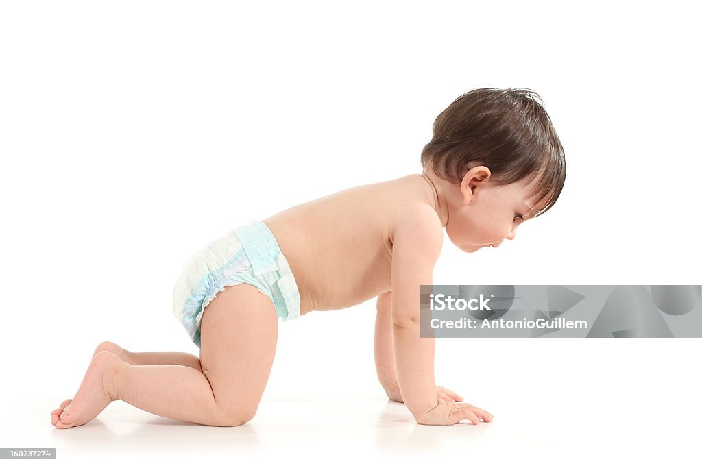 Baby crawling and watching down Baby crawling and watching down in a white isolated background Child Stock Photo
