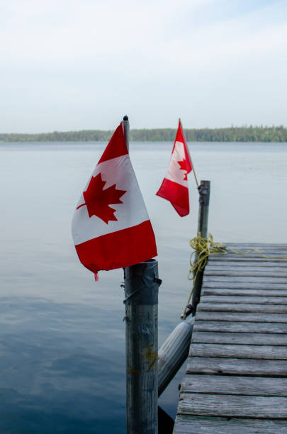 istock candaina flags on a dock in a peaceful lake in Manitoba 1602373536