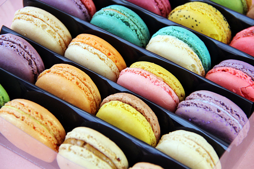 Macarons, delicious French pastries, are made of two egg white, almond, and sugar cookies sandwiching a cream, ganache, or fruit-based filling.