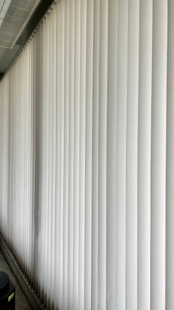 istock Window blinds with vertical wooden slats in room 1602399070