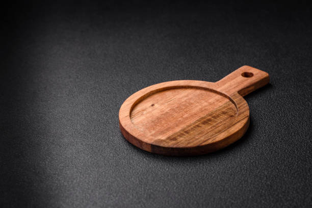 istock Empty round kitchen wooden cutting board in brown color 1602440677