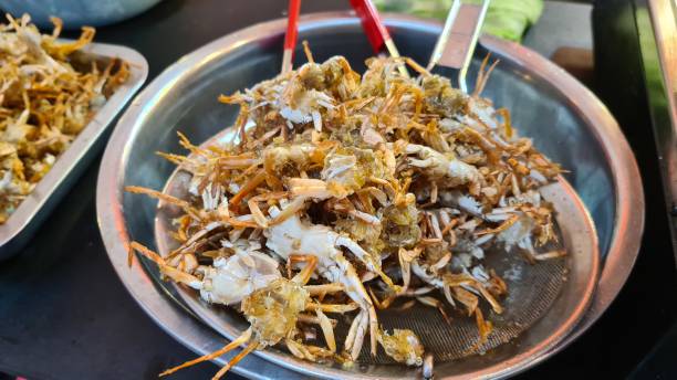 istock Fried baby crab on a aluminium tray. 1602445813