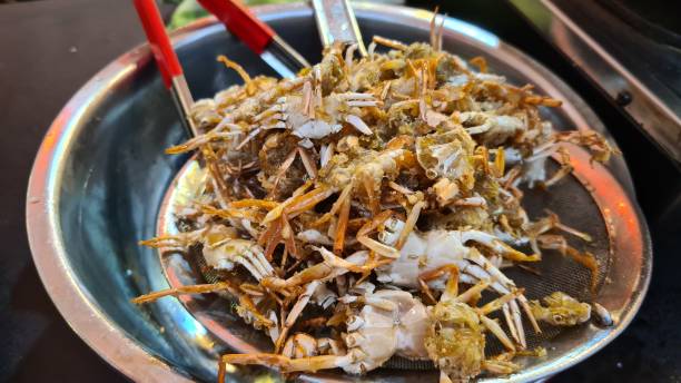 istock Fried baby crab on a aluminium tray. 1602446053