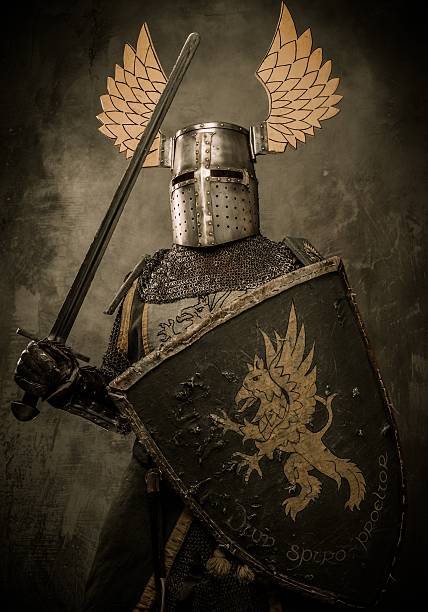 istock Medieval knight with sword and shield against stone wall 160246109