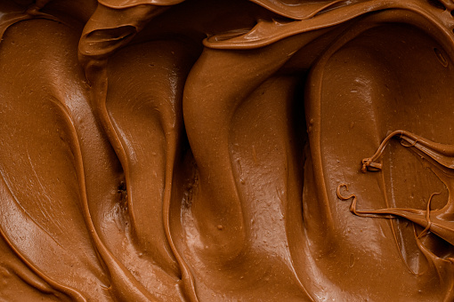 Ganache with salted caramel taste. Cream to fill or decorate desserts or cakes. Closeup view.