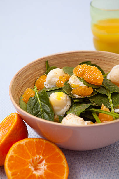 istock salad with mandarins and poached quail eggs 160249169