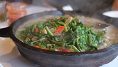 sizzling Kangkung or Water Spinach served on a hotplate.