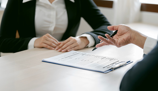 Business people negotiating and signing a contract.