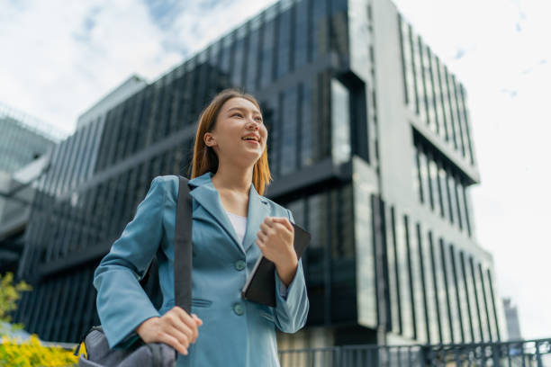 istock Efficiency Unleashed. Young Asian Businesswoman Empowers Business on the Go With A Digital Tablet Against a Contemporary Corporate Buildings in a Central Business District 1602495404