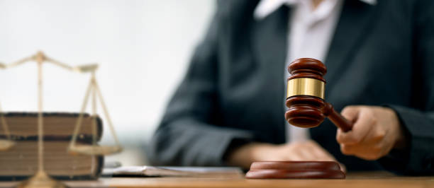 istock Female Judge with gavel on table 1602507424