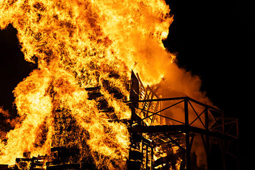 Stack of pallets on fire for the bonfire of Saint-Jean, a festive moment and an annual tradition in the villages of France