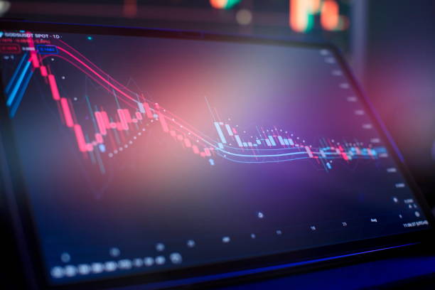 istock graph hologram on table with computer background. Concept of financial markets. 1602516928