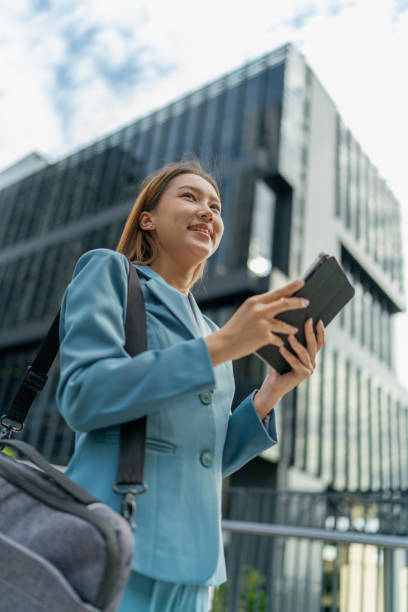 istock Efficiency Unleashed. Young Asian Businesswoman Empowers Business on the Go With A Digital Tablet Against a Contemporary Corporate Buildings in a Central Business District 1602517963