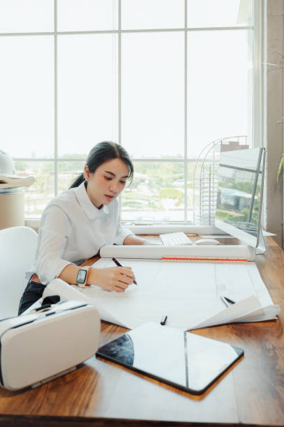 istock Selective focus, Asian female architect or engineer Currently considering materials for designing modern condominiums. Asian female architect or engineer Sit and analyze, design projects in the office 1602535264