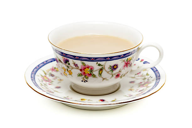 Cup of tea with milk on white stock photo