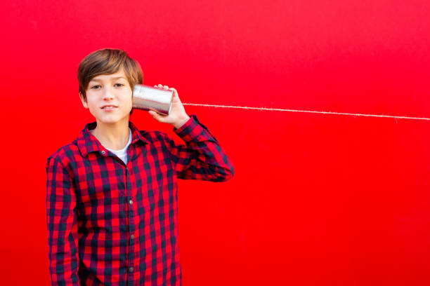 istock Boy playing with a handmade toy telephone 1602562327