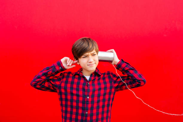 istock Boy playing with a handmade toy telephone 1602562329