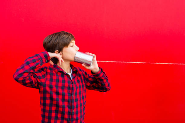 istock Boy playing with a handmade toy telephone 1602562331