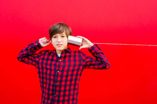 istock Boy playing with a handmade toy telephone 1602562334