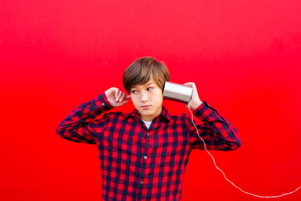 istock Boy playing with a handmade toy telephone 1602562439