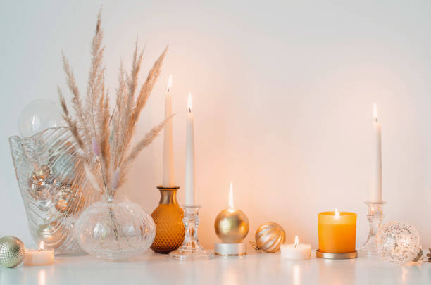 istock christmas decorations with burning candles in white room 1602565969
