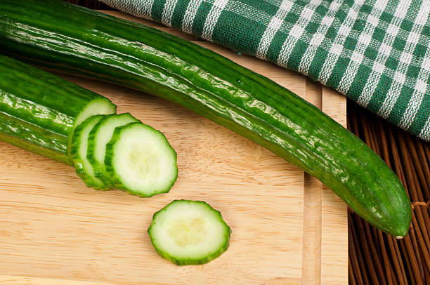 istock Sliced ​​cucumber on a wooden board 160259276
