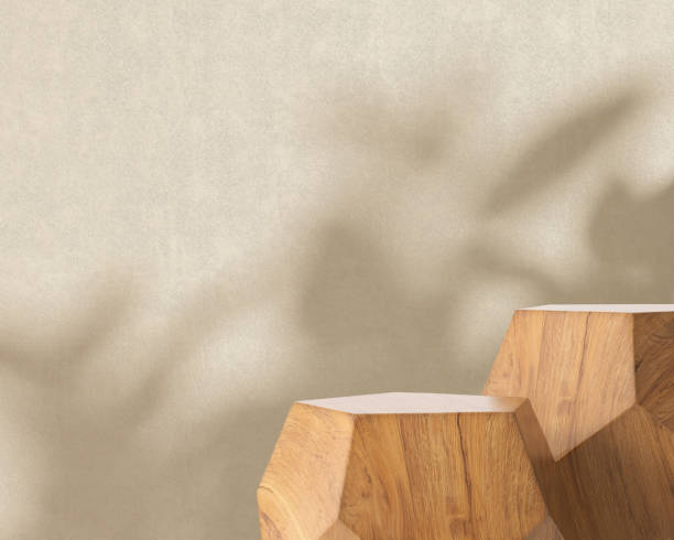 istock Two modern geometric shape wooden podium table, pentagon side in sunlight, tropical leaf foliage shadow on beige brown wall 1602606720