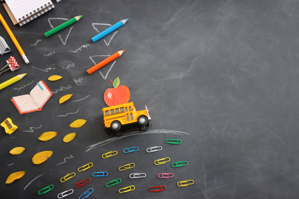 istock Back to school concept. bus and pencils over classroom blackboard. Top view 1602655652