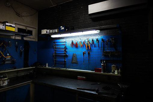 Work tools hanging on wall at workshop