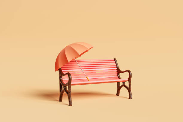 istock Empty red painted bench with orange umbrella on beige backdrop 1602692322