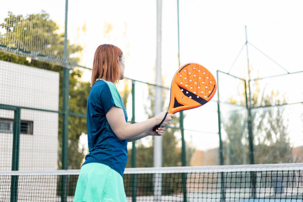 istock An unrecognizable girl in sportswear is posing on her back with a paddle racket before an outdoor match. Concept of women playing paddle. Paddle for girls. Paddle sport. 1602693517